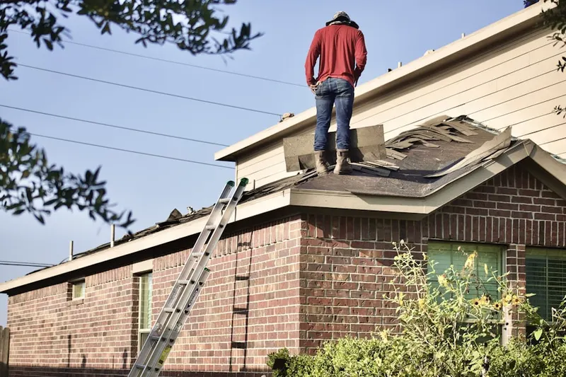 Professional roofer working on a residential roof in Green Meadows